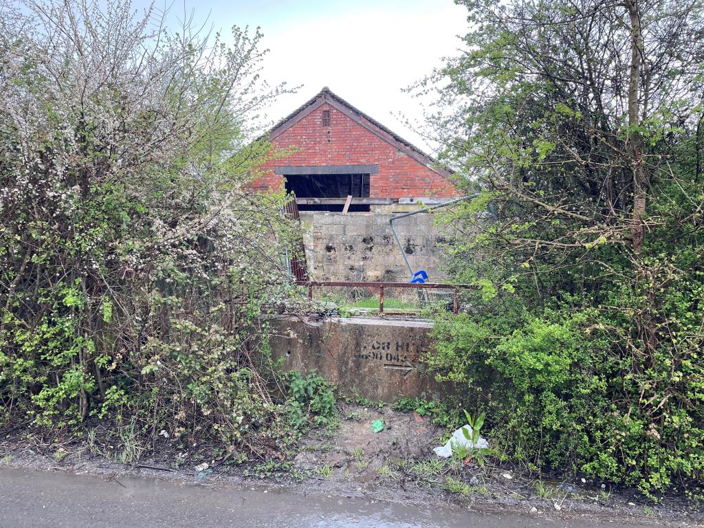 Lot: 18 - 13 PARCELS OF LAND WITH POTENTIAL IN STRATEGIC LOCATION - view of diused dairy building from Mill Road